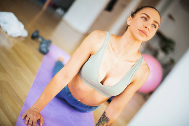 istock Young woman stretching abdominal muscles. 1285152010
