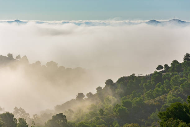 istock Mountain with antennas on its summit that protrudes through the clouds 1285152084