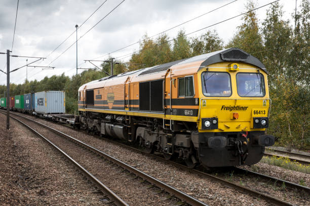 Freightliner Ltd Class 66 freight locomotive in Genesee and Wyoming livery Doncaster, UK - October15, 2020. A Freightliner Class 66 locomotive and Intermodal Shipping container freight train moving cargo boxes to ports and terminals in the UK doncaster photos stock pictures, royalty-free photos & images