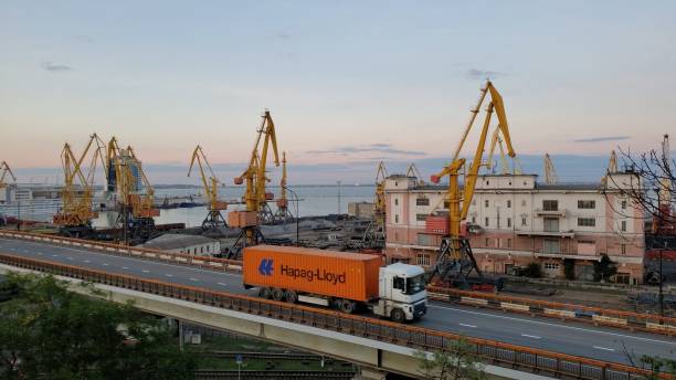 Industrial port landscape with Hapag-Lloyd container truck driving by overpass stock photo
