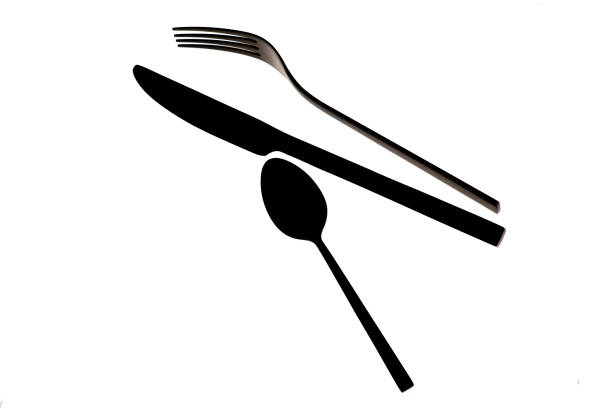 Printed or marked knife and fork made with cocoa powder in white plate with copy space.Not an illustration