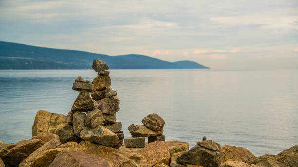 La Malbaie, Canada - August 17 2020: Stunning landscape view with the prayer stones by the holy lawrence river in La Malbaie in Quebec La Malbaie, Canada - August 17 2020: Stunning landscape view with the prayer stones by the saint lawrence river in La Malbaie in Quebec charlevoix photos stock pictures, royalty-free photos & images