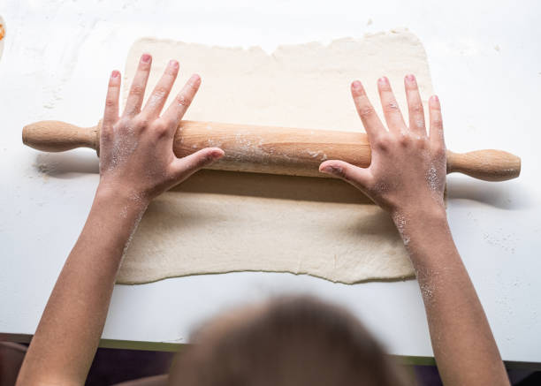 istock Close up girls hand on rolling pin 1285155169