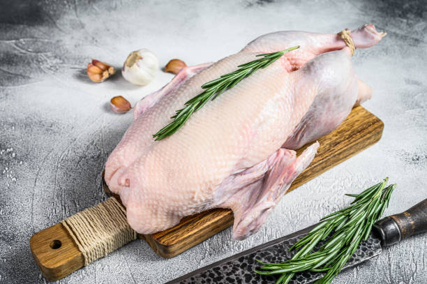 istock Raw whole goose, poultry meat. Black background. Top view 1285156020