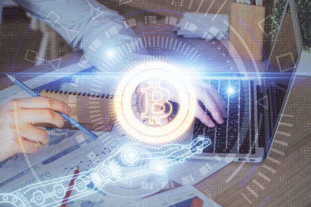istock Crypto currency theme hologram with businessman working on computer on background. Concept of blockchain. Double exposure. 1285156746