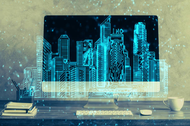 istock Desktop computer background in office and big town buildings hologram drawing. Double exposure. Smart city concept. 1285157579