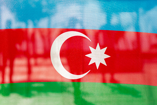 Azerbaijani flag and silhouettes of soldiers behind it