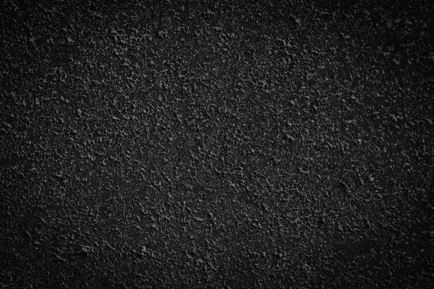 istock Abstract black background of concrete wall texture 1285158060