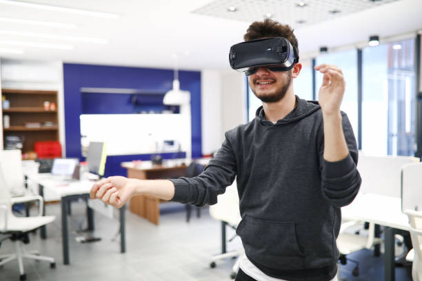 istock Casual Dressed Young Man Having Fun With VR Glasses During Office Break 1285158062