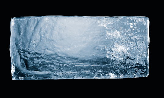 Textured natural ice block, isolated on black background. Clipping path included.