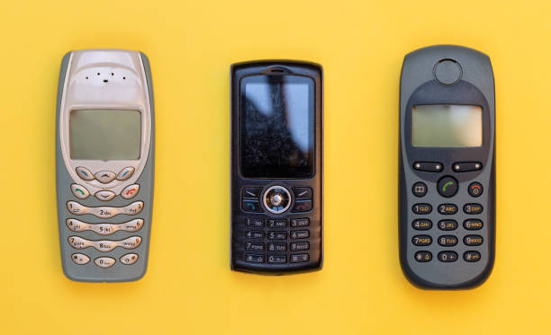 istock Obsolete three mobile phones on a yellow background 1285159162
