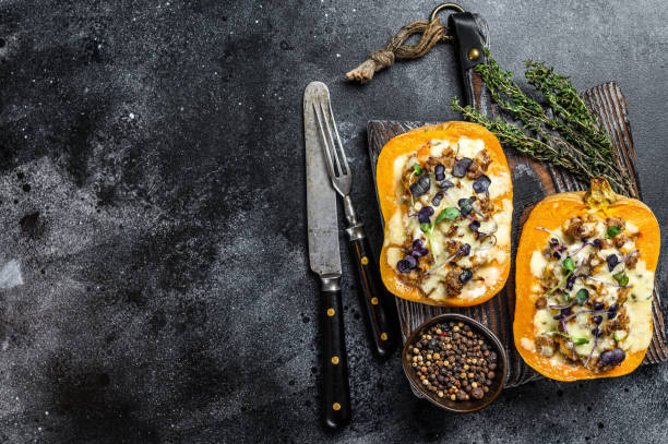 istock Pumpkin stuffed with mince beef meat, vegetables and herbs Black background. Top view. Copy space 1285160470
