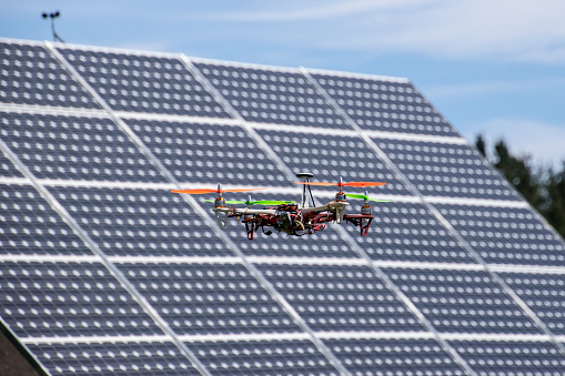 Drone flying over solar panels in a photovoltaic plant