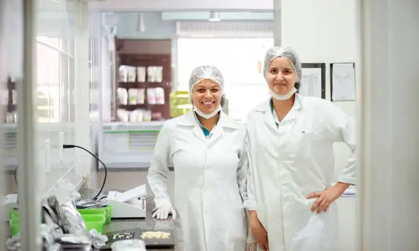 Portrait of two confident female pharmacists working in a chemist lab