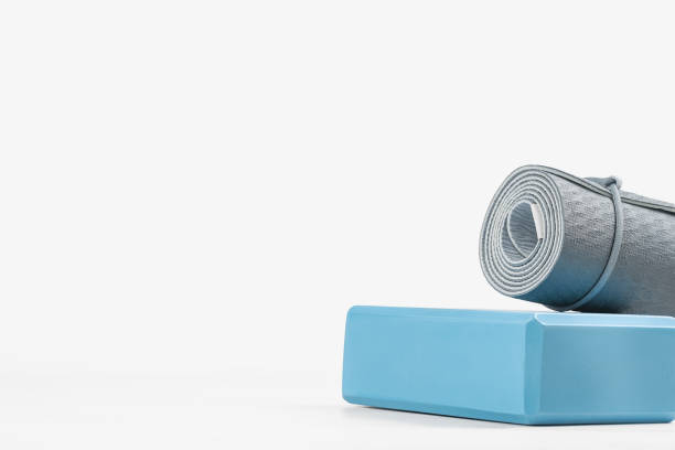 istock Rolled yoga mat and yoga block or brick 1285162208