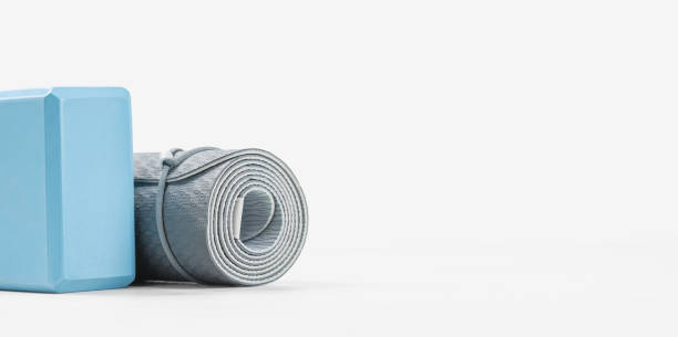 istock Rolled yoga mat and yoga block or brick 1285162209