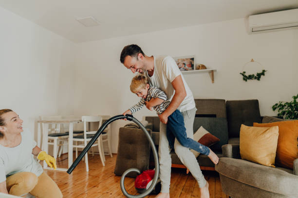 Cleaning our home together Photo of a little boy and his parents, deep cleaning their home due to coronavirus pandemic father housework stock pictures, royalty-free photos & images