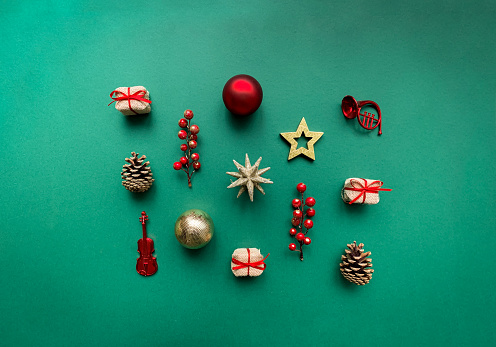 Christmas composition made of Christmas decorations on green background. Flat lay, top view.