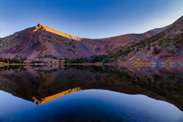 istock Mountain reflection at sunset with autumn colors 1285165518