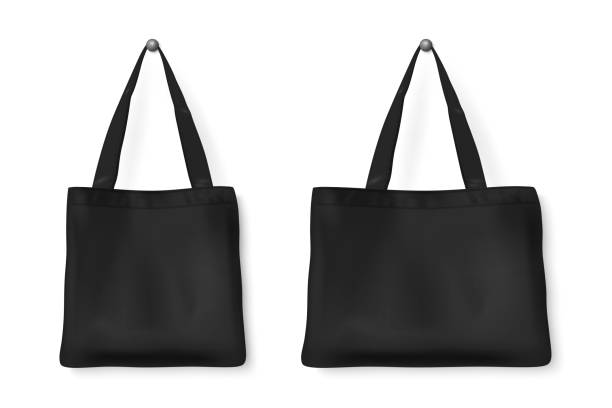 istock Vector 3d Realistic Blank Black Detailed Textile Tote Shopping Bag Set Hanging on the White Wall Background, Isolated. Design template for Mockups, Logo Design, Packaging. Ecology concept. Front View 1285166462