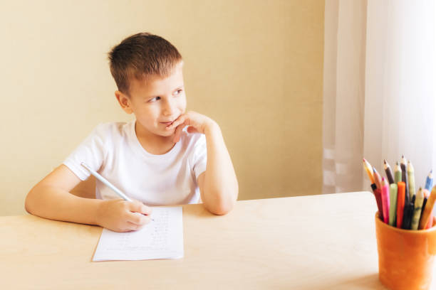istock cute little boy learning at home. 1285166624