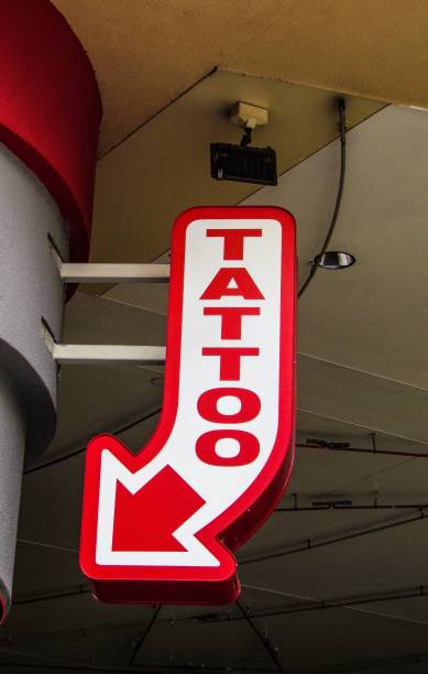istock Directional sign pointing to a tattoo parlor 1285167559