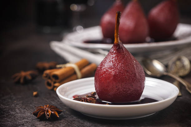 Poached Pears in Red Wine for the Holidays Poached pears in red wine for the holidays at home pear dessert stock pictures, royalty-free photos & images