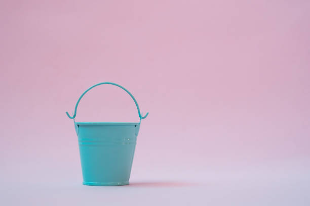 istock Light blue bucket on a pink background 1285169515