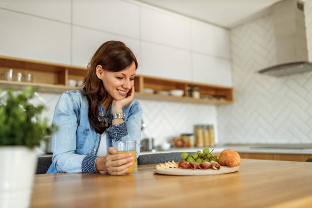 istock Holding glass of orange juice. 1285170818