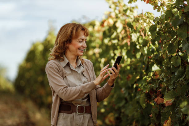 istock Women taking pictures of fruit tree. 1285170854