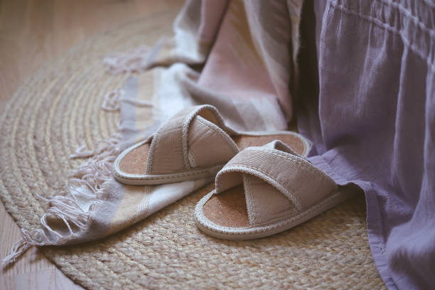 istock Home slippers by the bed on a wicker rug 1285171660