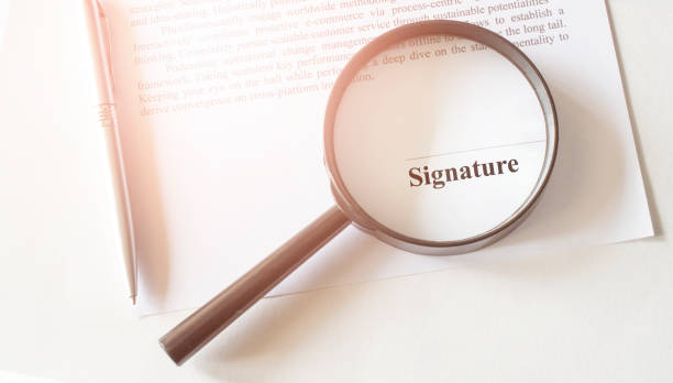 istock Signaure line in contract with pen and magnifying glass 1285173245