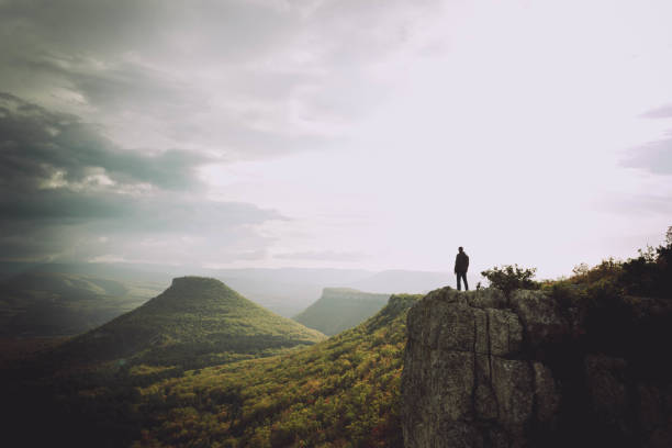 istock Man on the cliff edge landscape 1285173277