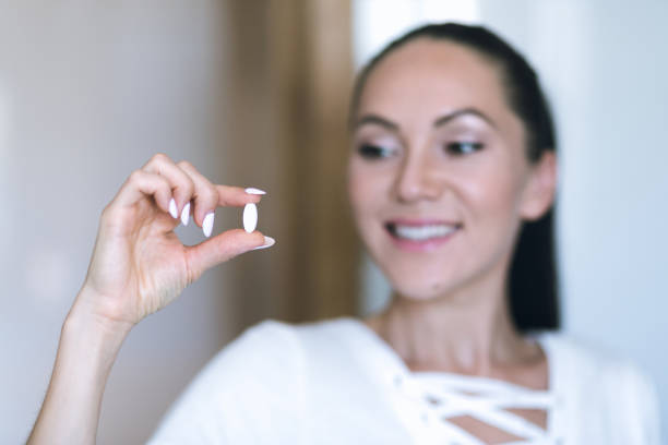 istock Woman drinks pills she think about her health 1285175269