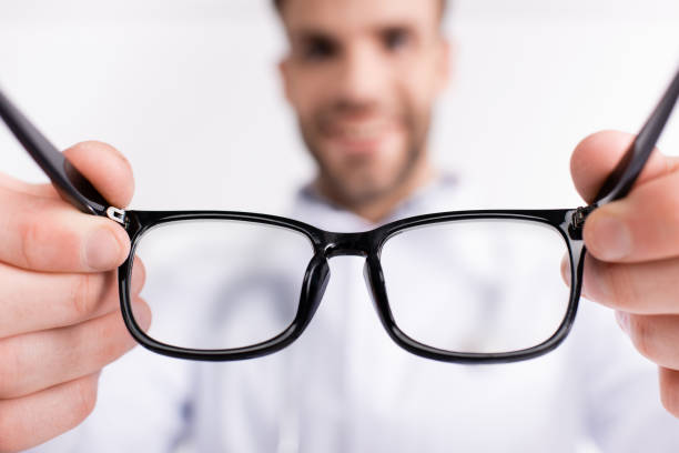 istock Eyeglasses with black frame with blurred doctor on background 1285176400