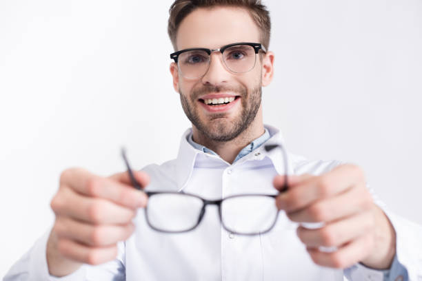 istock Smiling ophthalmologist putting eyeglasses isolated on white on blurred foreground 1285176431