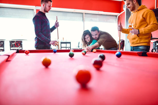 istock Male Helping Girlfriend Aim True While Playing Snooker With Her 1285176443