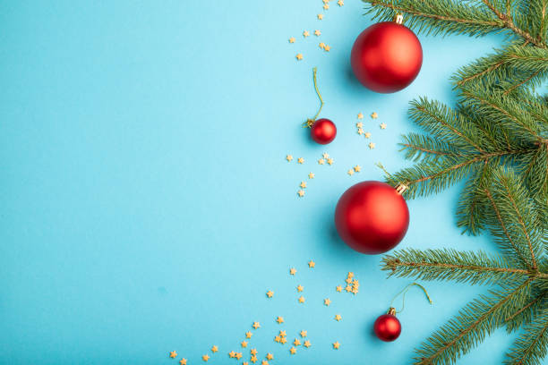 istock Christmas or New Year composition. Decorations, red balls, fir and spruce branches, on a blue paper background. Top view, copy space, flat lay. 1285176982