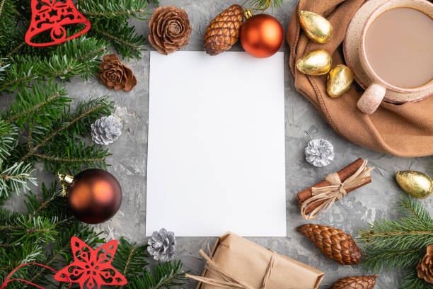 istock Christmas or New Year frame composition, template. Decorations, cones, cinnamon, fir and spruce branches, cup of coffee, wool scarf on a gray concrete background. Top view, copy space, flat lay. 1285176983