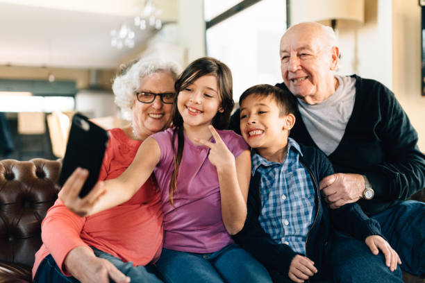 istock Grand parents and grand children using digital tablet 1285177187