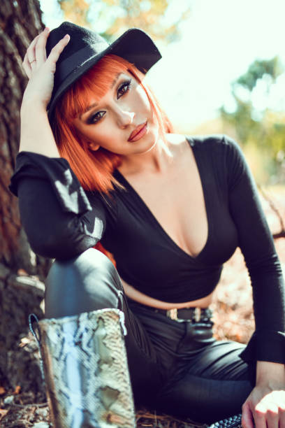 istock Cowgirl In Leather Clothing Relaxing Under Tree 1285177343