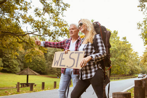 istock A middle-aged couple is hitchhiking 1285181555