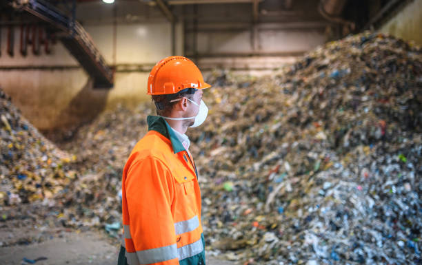 istock Male Recycling Expert Observing Pile of Processed Waste 1285181662