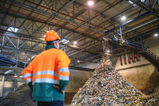 istock Worker Observing Processing of Waste at Recycling Facility 1285181695