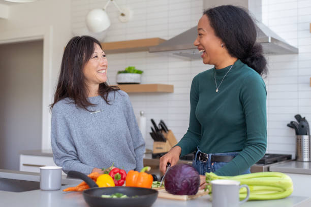 istock Teenage daughter cooking dinner with her mom 1285181720