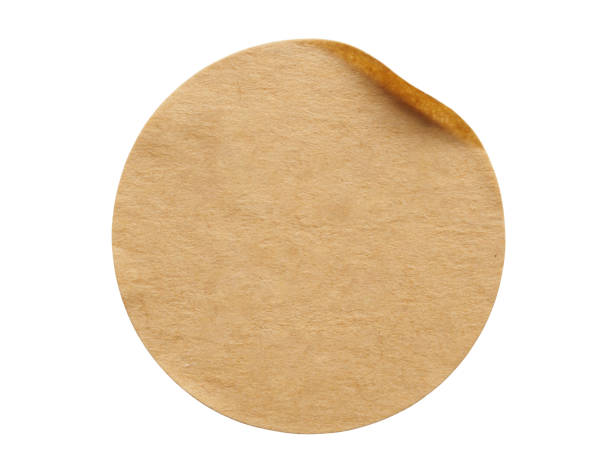istock Brown round paper sticker label isolated on white background 1285181955