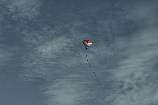 Beautiful kite in the sky against the background of clouds. Passion and hobby. Spending time in nature