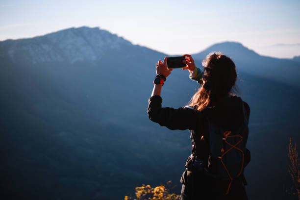 istock Female hiker photographing the landscape 1285182338