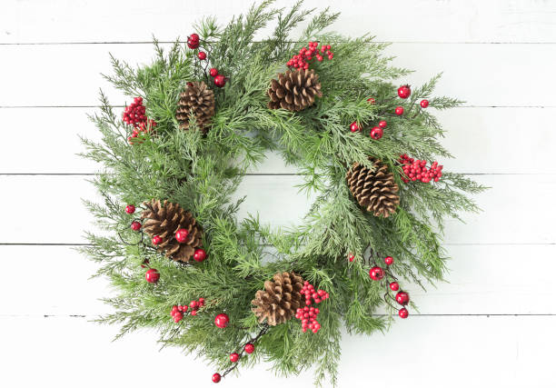 istock Christmas wreath on an old white wood background 1285183854