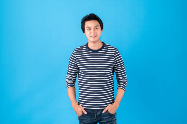 istock Portrait handsome young Asian man standing over blue background 1285183874